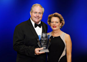 Bill and Teresa Christie hold award