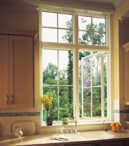 Pair of casement windows with grids, one of which is open, over a kitchen sink and counter
